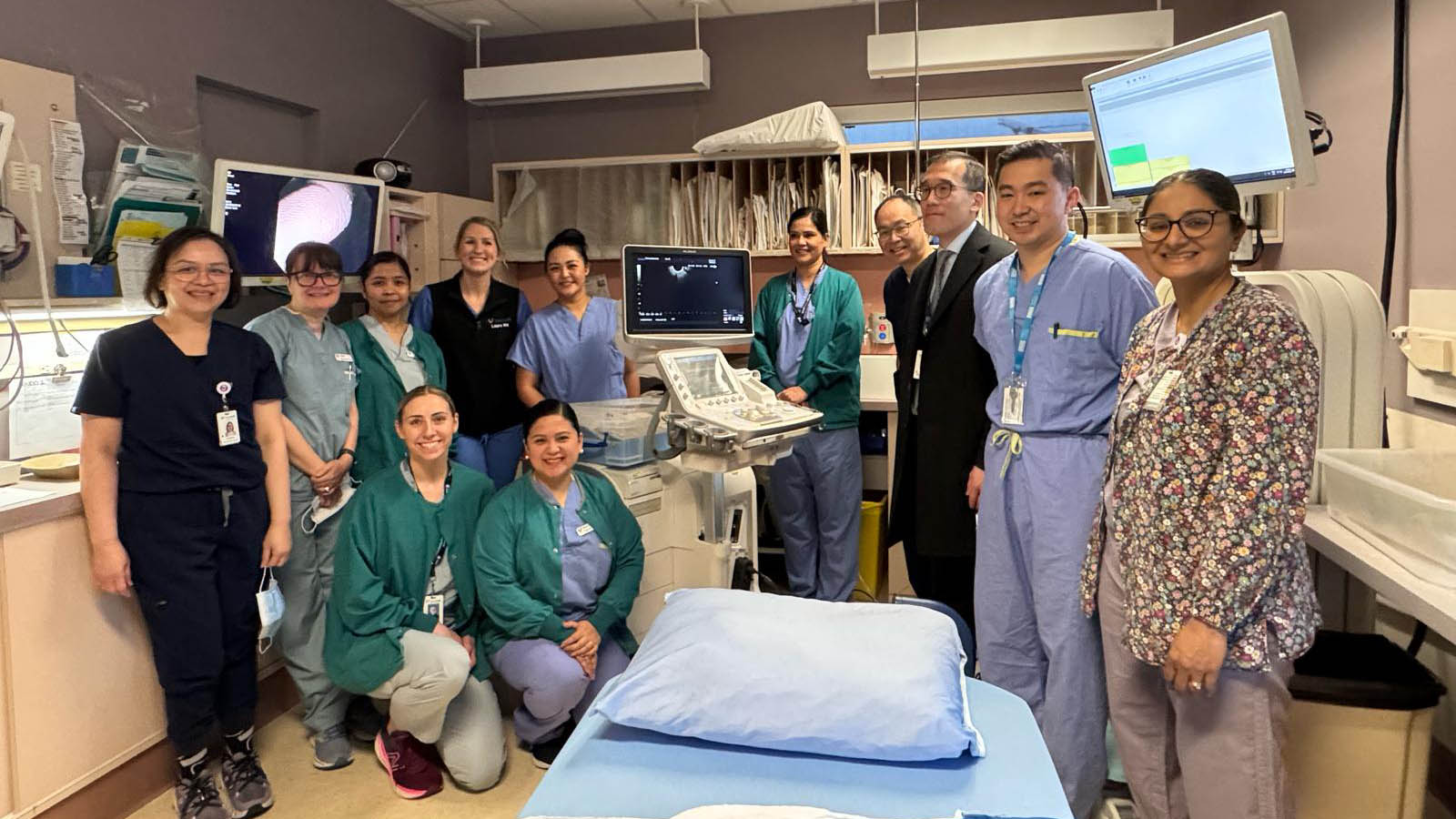 A number of physicians and nurses stand next to an ambulatory day care bed.