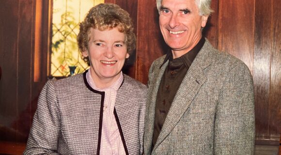 Scanned photo of Joan and Leonard Leece, smiling at the camera.