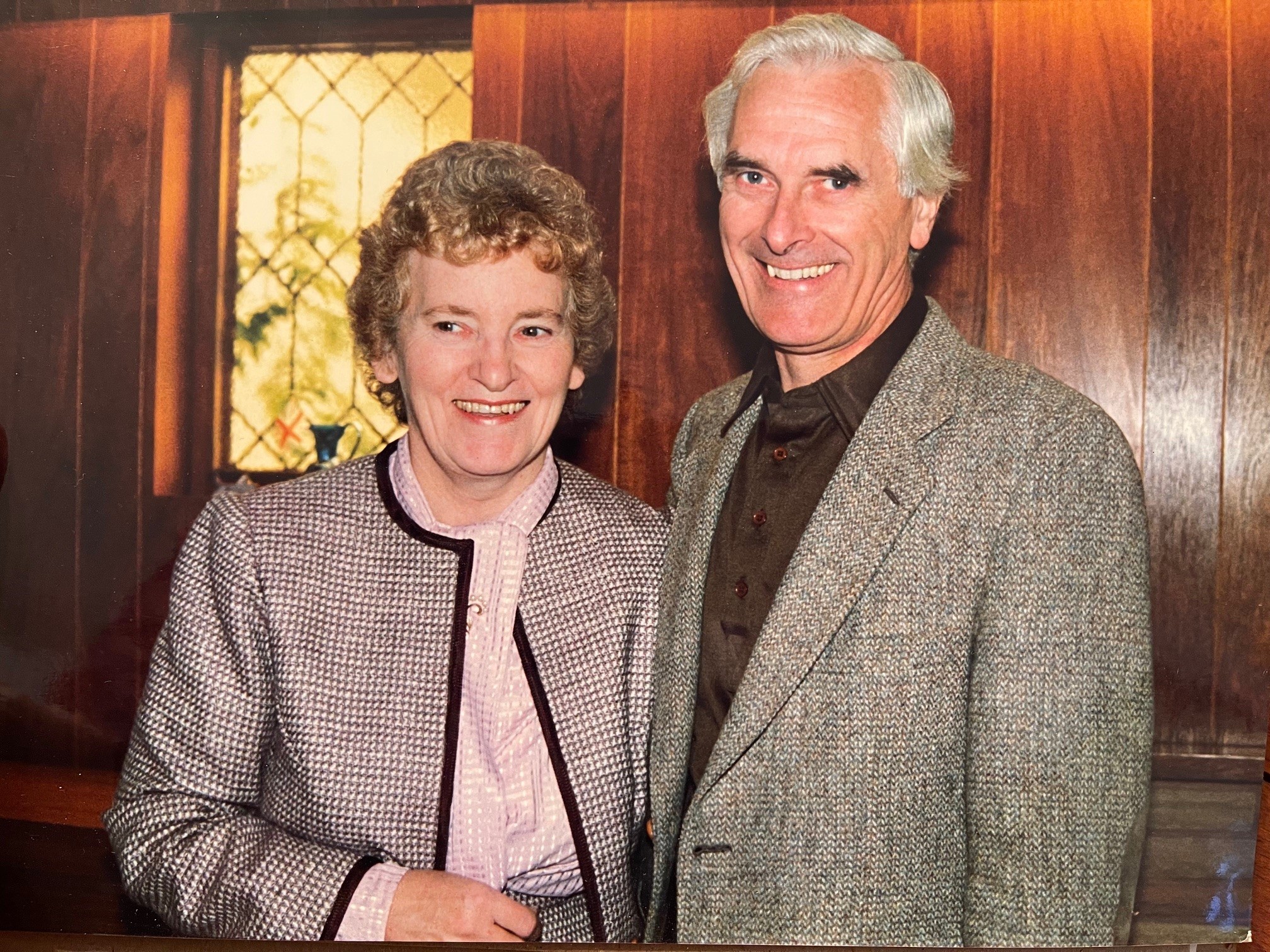 Scanned photo of Joan and Leonard Leece, smiling at the camera.