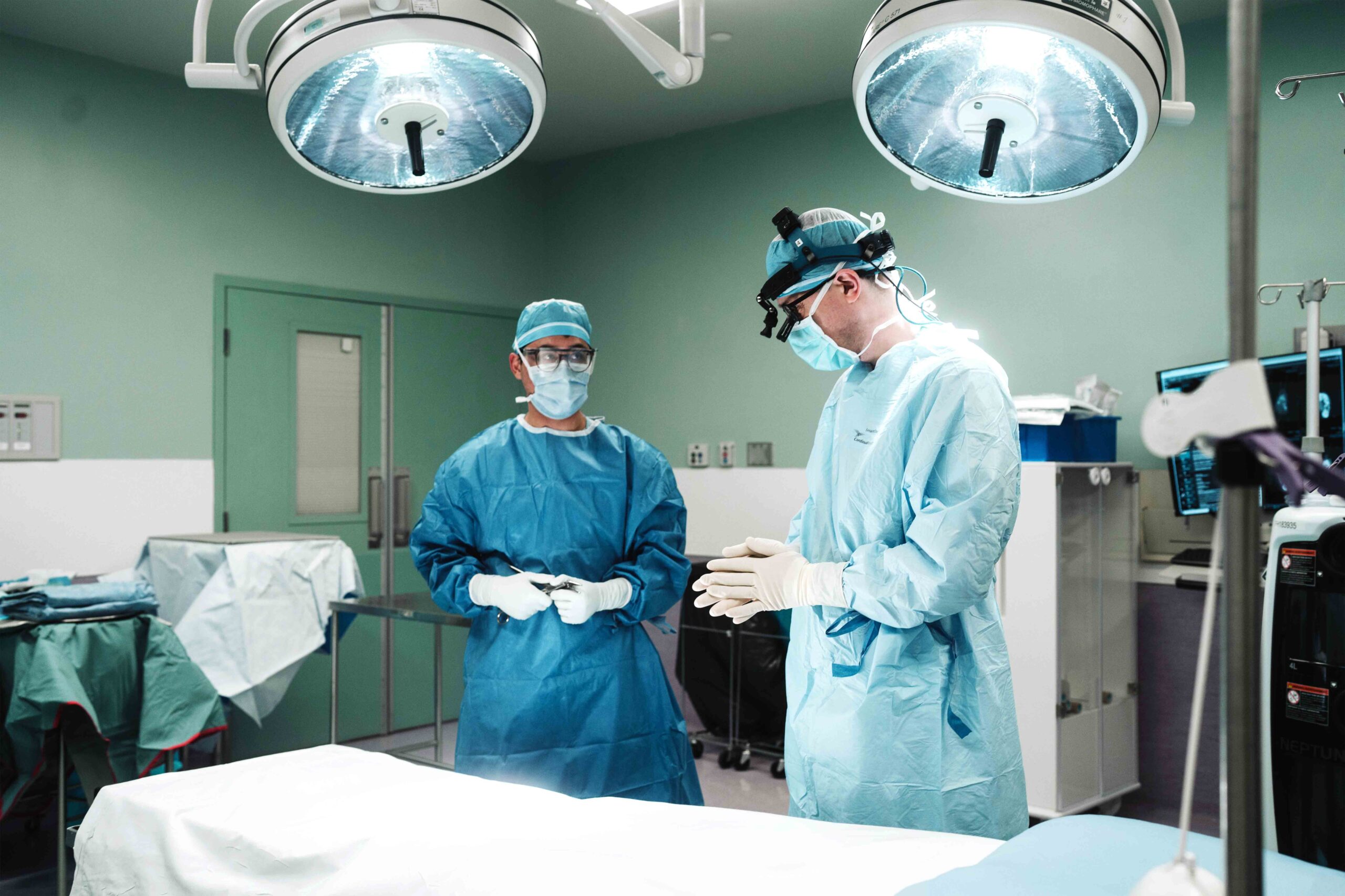 Two surgeons in a surgery room preparing for surgery